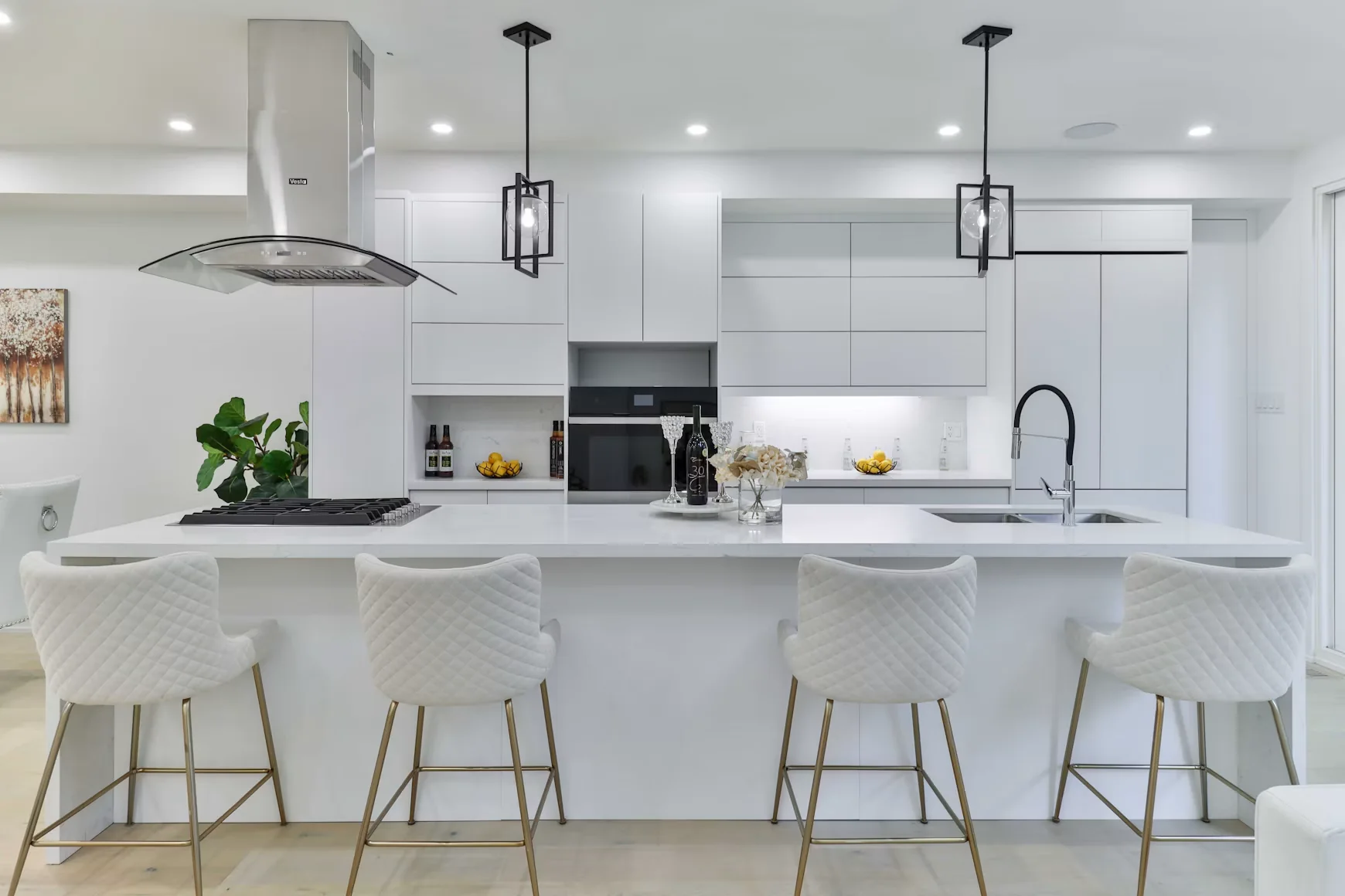 Contemporary white kitchen with a generous island, streamlined cabinets and four upholstered stools
